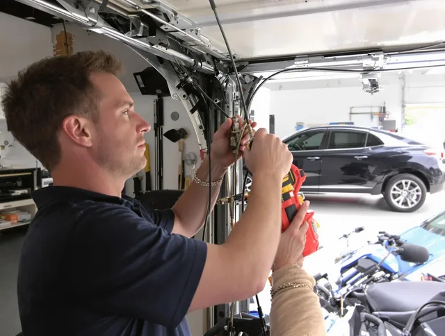 Pembroke Garage Door Repair safety certified technician performing cable replacement in Pembroke