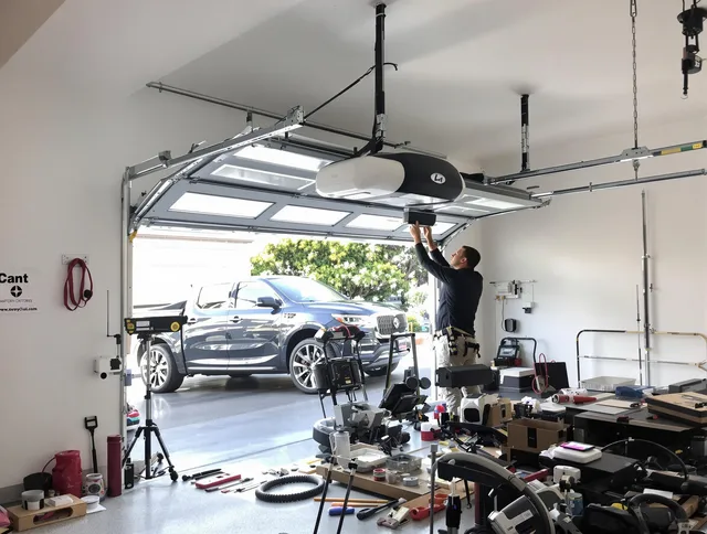 Pembroke Garage Door Repair specialist installing smart garage door opener system in Pembroke home