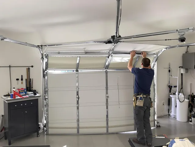 Pembroke Garage Door Repair specialist performing precise section replacement on Pembroke garage door